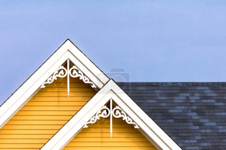 Detail of the gingerbread style fretwork of the typical wooden houses of Iles de la Madeleine, or the Magdalen Islands, in Canada. Minimalistic style in primary colours with space for text.