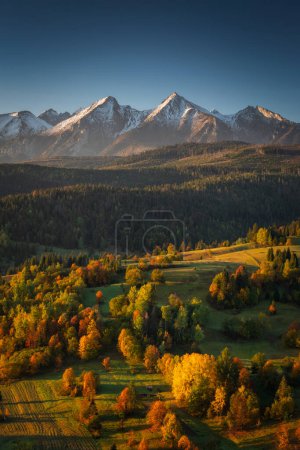 Photo for Beautiful autumn with red an yellow trees under the Tatra Mountains at sunrise. Slovakia - Royalty Free Image
