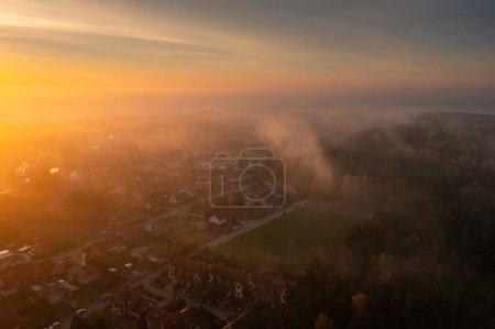 Photo for Morning fog over the forest and buildings in northern Poland - Royalty Free Image