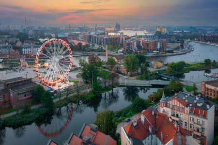 Photo for Ferris wheel by the Main Town of Gdansk over the Motlawa river at sunset, Poland. - Royalty Free Image