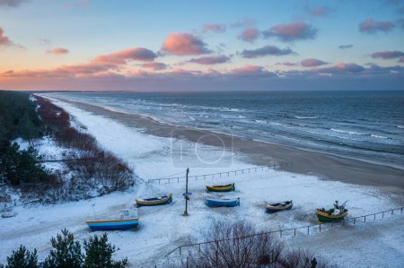 Photo for Fishing boats on the Baltic Sea beach in Jantar at winter. Poland - Royalty Free Image