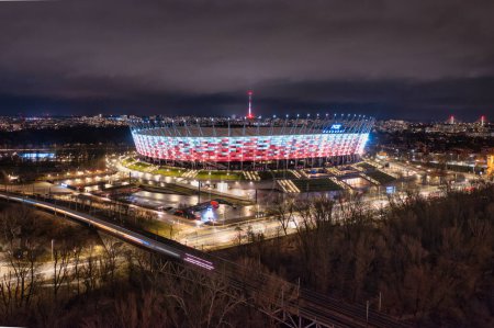 Photo for Warszawa, Poland - January 27, 2024: The National Stadium in Warsaw illuminated in Poland's national colors at night. - Royalty Free Image