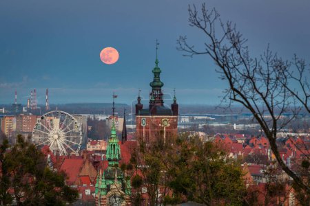 Photo for A full moon rising over the city of Gdansk at dusk. Poland - Royalty Free Image