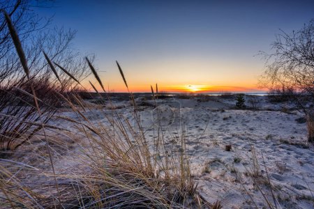 Photo for A beautiful sunset on the beach of the Sobieszewo Island at the Baltic Sea at spring. Poland - Royalty Free Image