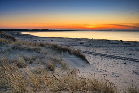 Foto de Una hermosa puesta de sol en la playa de la isla de Sobieszewo en el Mar Báltico en primavera. Polonia - Imagen libre de derechos
