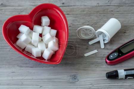 Heart shaped bowl and sugar cubes. Diabetes testing