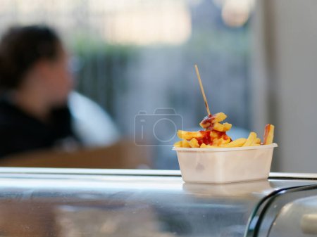 Photo for French fries in a box on a table near the beach of the North Sea. - Royalty Free Image