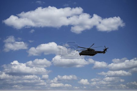 Photo for Military helicopter flying in blue sky. High quality photo - Royalty Free Image