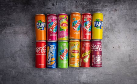 Photo for December 21 2022 : Lyon, Rhone Alpes Auvergne, France : groups of cans of sweetened sodas. Famous brands on a background of material - Royalty Free Image