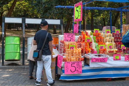 Foto de MEXICO CITY, MEXICO. March 24, 2022: Treats stand iwith batanas, chips, maxican snachs n Chapultepec park, Mexico City, Mexico, - Imagen libre de derechos