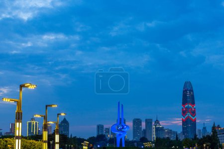 Photo for June 27, 2023 - Jinan, China: The large spring sculpture on Quancheng square and skyline of Jinan with the Greenland Puli center in the city at night time - Royalty Free Image