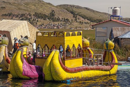 Photo for Uros, Peru - April 29, 2022: Tourist boats made of reed moored at Uros Islands, Lake Titicaca, Peru - Royalty Free Image