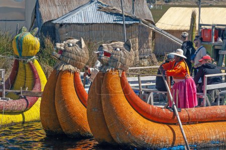 Photo for Uros, Peru - April 29, 2022: Tourist boats made of reed moored at Uros Islands, Lake Titicaca, Peru - Royalty Free Image