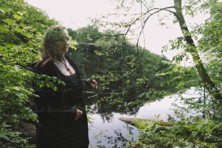 Woman an black  in the forest near the lake an d swarps , multiexposition