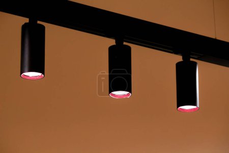 Three lamps and orange wall abstract background