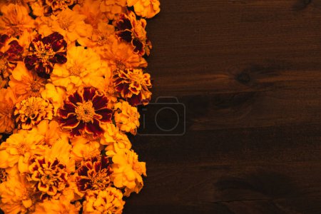 Photo for Marigold yellow flowers over rustic wooden background. Concept Diwali Festival, Day of the Dead Mexican Festival, Chinese mid autumn festival, holiday template. Top view, flat lay, copy space - Royalty Free Image