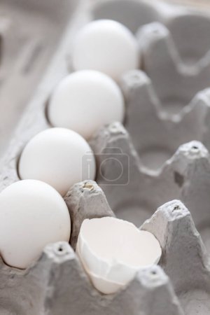 Photo for Carton of White Chicken Eggs and Egg Shells. - Royalty Free Image