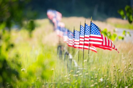 Photo for Row of American Flags  Waving in the Wind Along A Fence. - Royalty Free Image