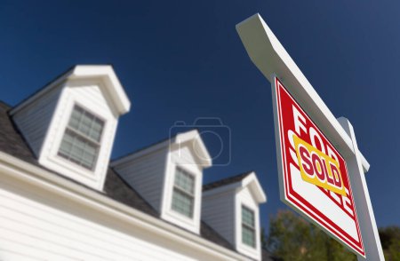Photo for Sold For Sale Real Estate Sign in Front of New House. - Royalty Free Image