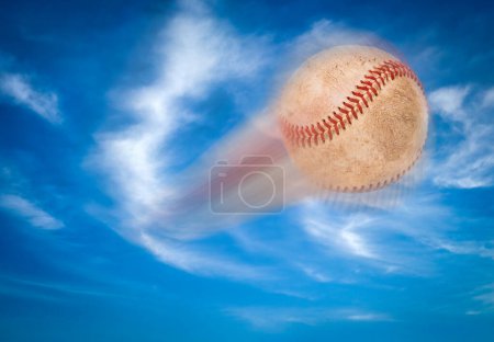 Foto de Baseball Flying Through The Air and Blue Sky. - Imagen libre de derechos