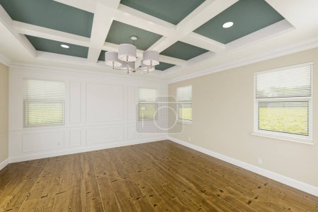 Photo for Beautiful Muted Teal and Tan Custom Master Bedroom Complete with Entire Wainscoting Wall, Fresh Paint, Crown and Base Molding, Hard Wood Floors and Coffered Ceiling - Royalty Free Image