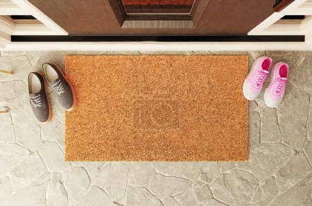 Photo for Overhead of blank doormat with man and woman shoes on the porch at the front door. - Royalty Free Image