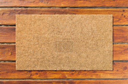 Overhead of blank doormat on the wood plank porch.
