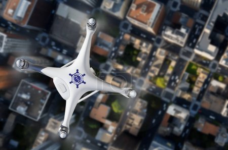 Top View of a Police Law Enforcement Drone UAV In Flight Over City Streets and Buildings.