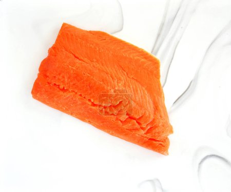 Fresh caught Pacific Ocean coho salmon filet in flat lay composition.  Healthy source of Omega 3.  Vibrant orange color on marble cutting board