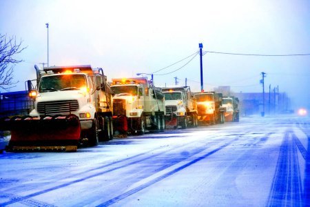 Photo for Snow plows in severe blizzard preparing for storm clearing street driving - Royalty Free Image