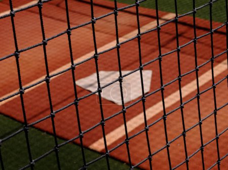 Photo for Baseball practice area fence with home plate for warm up pitching - Royalty Free Image