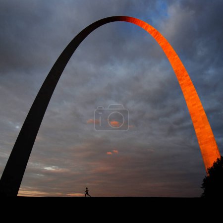 St Louis Arch landmark metal gateway sunset glowing orange