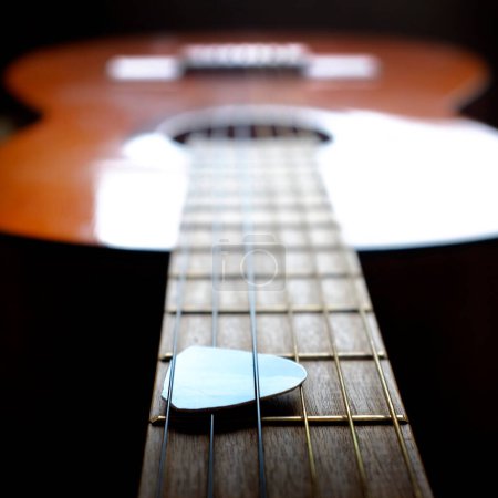 Photo for Closeup detail of guitar strings for playing music musical strands pick - Royalty Free Image