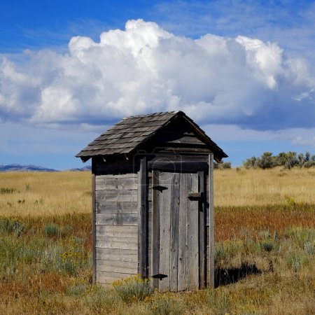 Photo for Old outhouse in prairie ghost town countryside abandoned historical area - Royalty Free Image