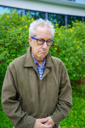 Foto de Grumpy old man in a weather jacket - Imagen libre de derechos