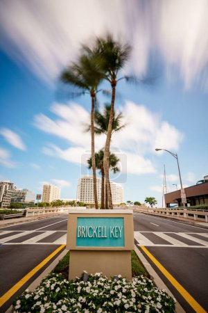 Photo for Entrance sign to Brickell Key Miami FL. Long exposure to blur tres and sky - Royalty Free Image