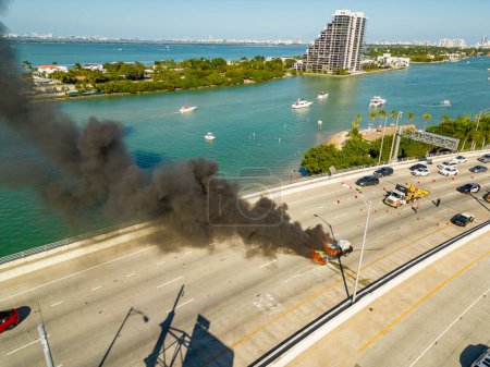 Photo for Aerial photo of a car on fire on a bridge in Miami - Royalty Free Image