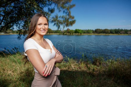 Photo for Beautiful young woman posing outdoors with arms crossed - Royalty Free Image