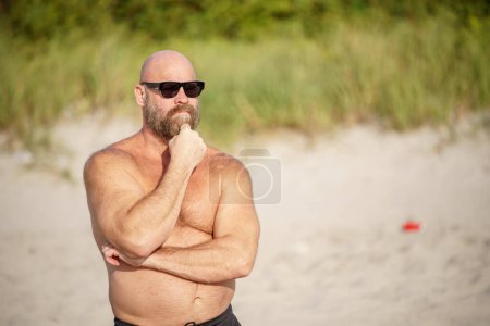 Photo for Bald man with beard posing with hand on chin - Royalty Free Image