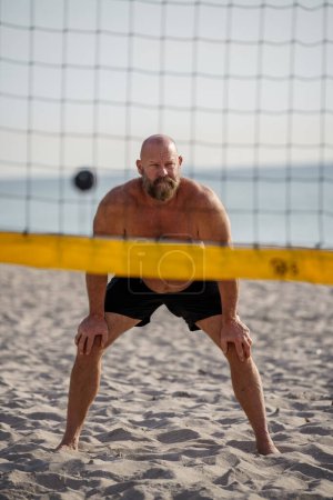Photo for Man playing volleyball on the beach - Royalty Free Image