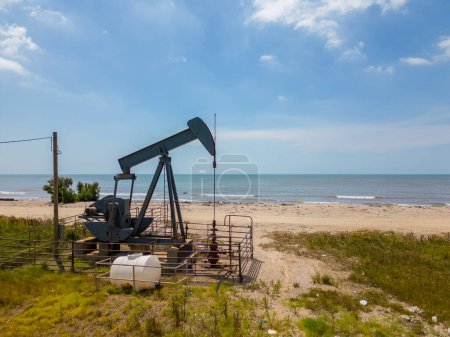 Photo for Photo of an old oil pumpjack on High Island Beach Texas - Royalty Free Image