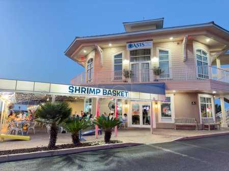 Photo for Pensacola Beach, FL, USA - July 21, 2023: Night photo of Shrimp Basket Restaurant Pensacola Beach Florida - Royalty Free Image