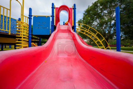 Photo for Low angle bottom of a park slide red - Royalty Free Image