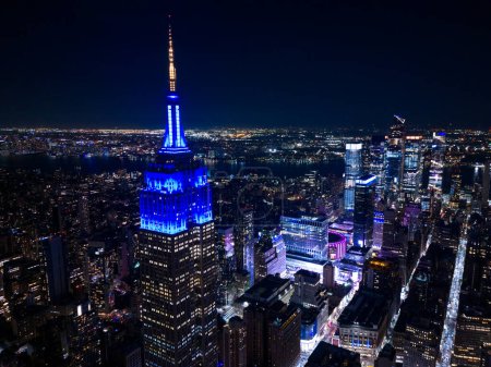 Photo for New York, NY, USA - October 25, 2023: Aerial photo Empire State Building lit blue at night - Royalty Free Image