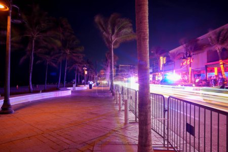 Photo for Fort Lauderdale, FL, USA - March 30, 2024: View of the sidewalk on A1A Fort Lauderdale night Spring Break - Royalty Free Image