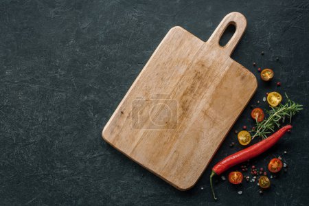 Photo for Horizontal background with cutting board and spices, pepper, tomato and other ingredients. Place for text - Royalty Free Image