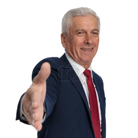 Foto de Happy old businessman ready to shake hands while smiling - Imagen libre de derechos