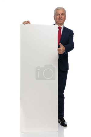 Photo for Full body picture of an Old businessman giving a thumbs up showing everything is ok with his billboard - Royalty Free Image