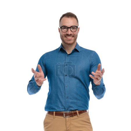 Photo for Portrait of happy handsome guy with glasses smiling and posing in front of white background in studio - Royalty Free Image