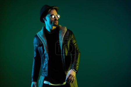 Photo for Portrait of handsome casual man looking to the side with tough attitude in a play of colorful lights - Royalty Free Image